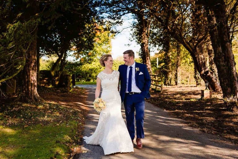 bride and groom walking at their burythorpe house wedding - fun and creative wedding photography by emma and rich