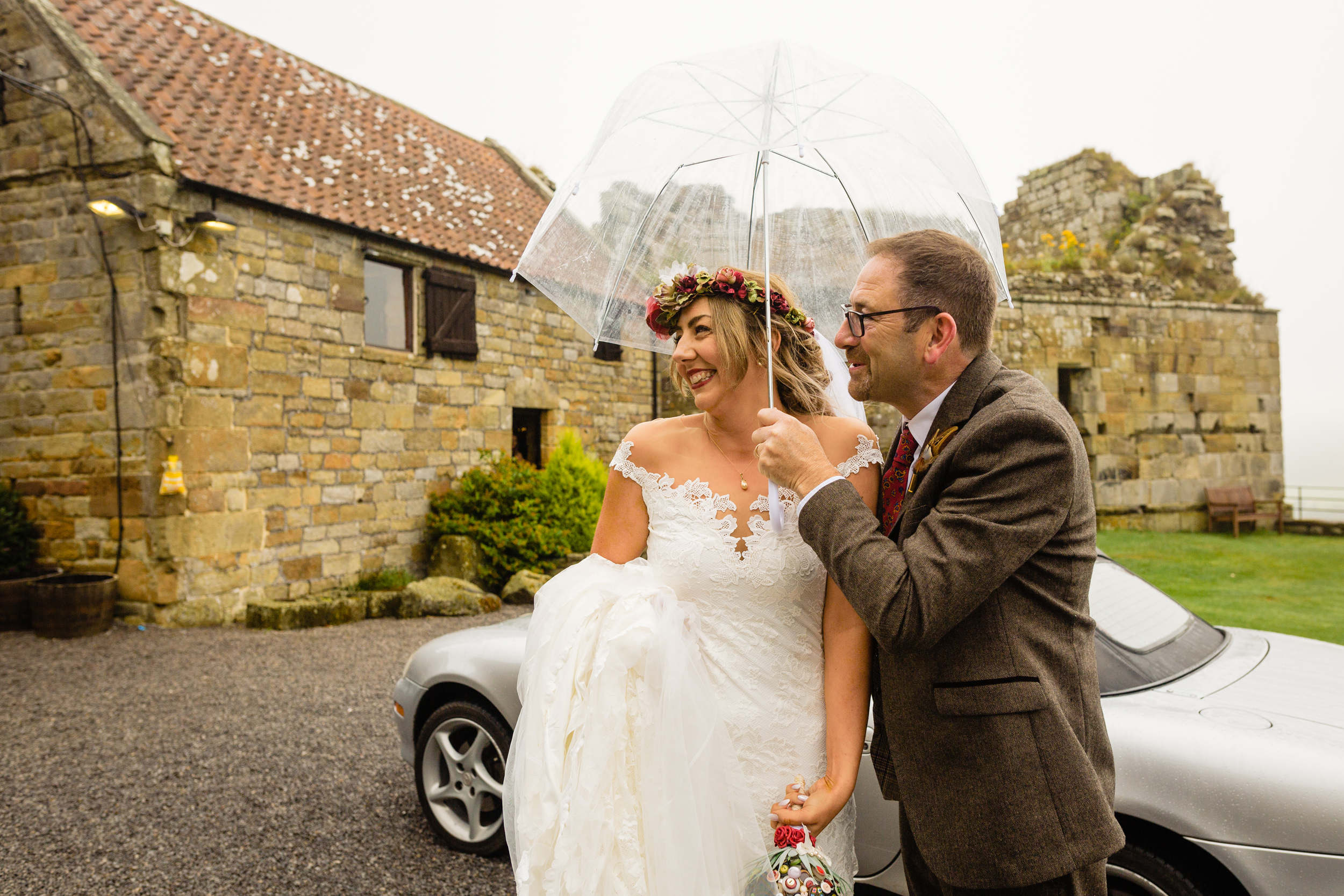 bride and father under umbrella. esk valley wedding photography by emma and rich.