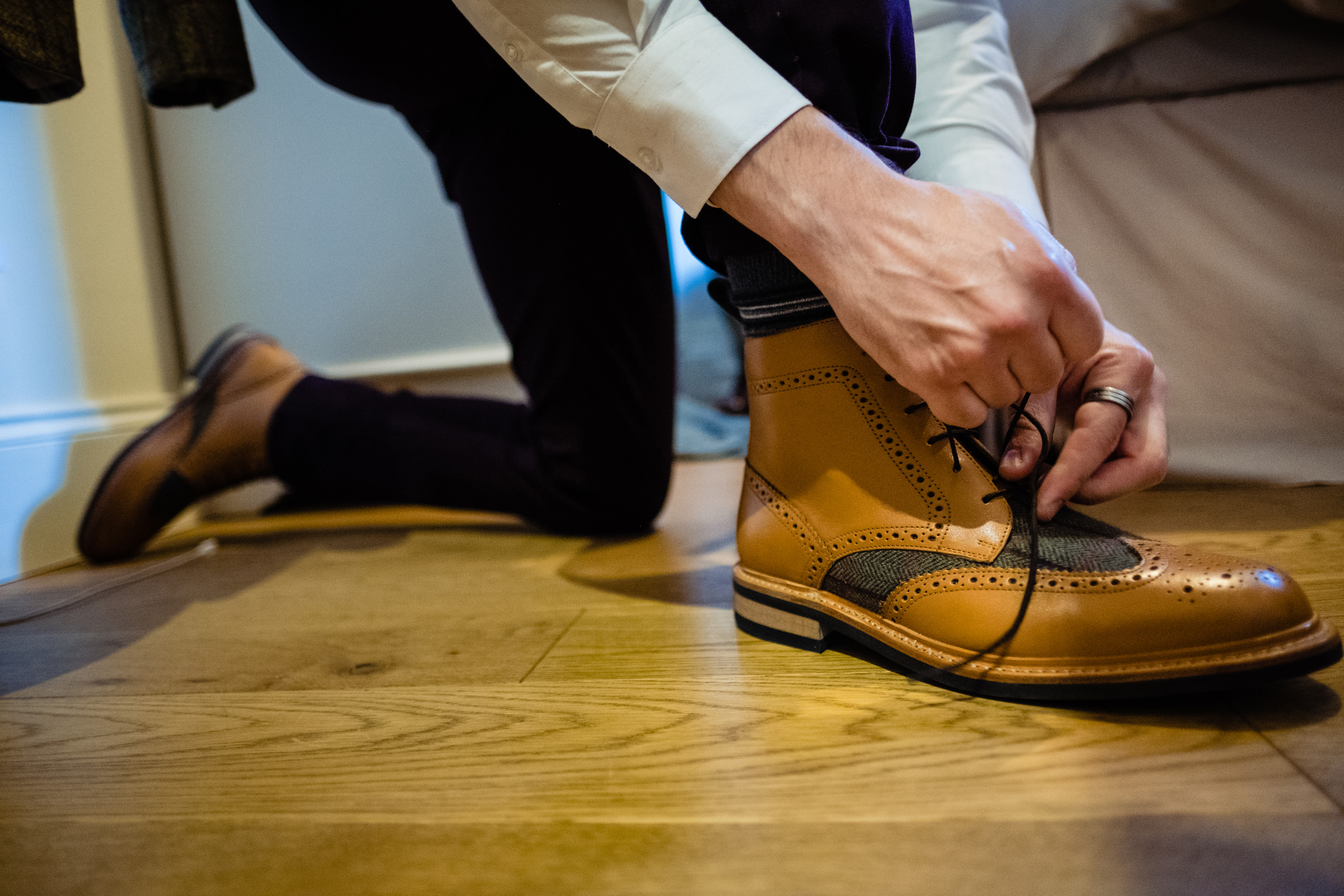 groom putting on shoes. esk valley wedding photography by emma and rich.