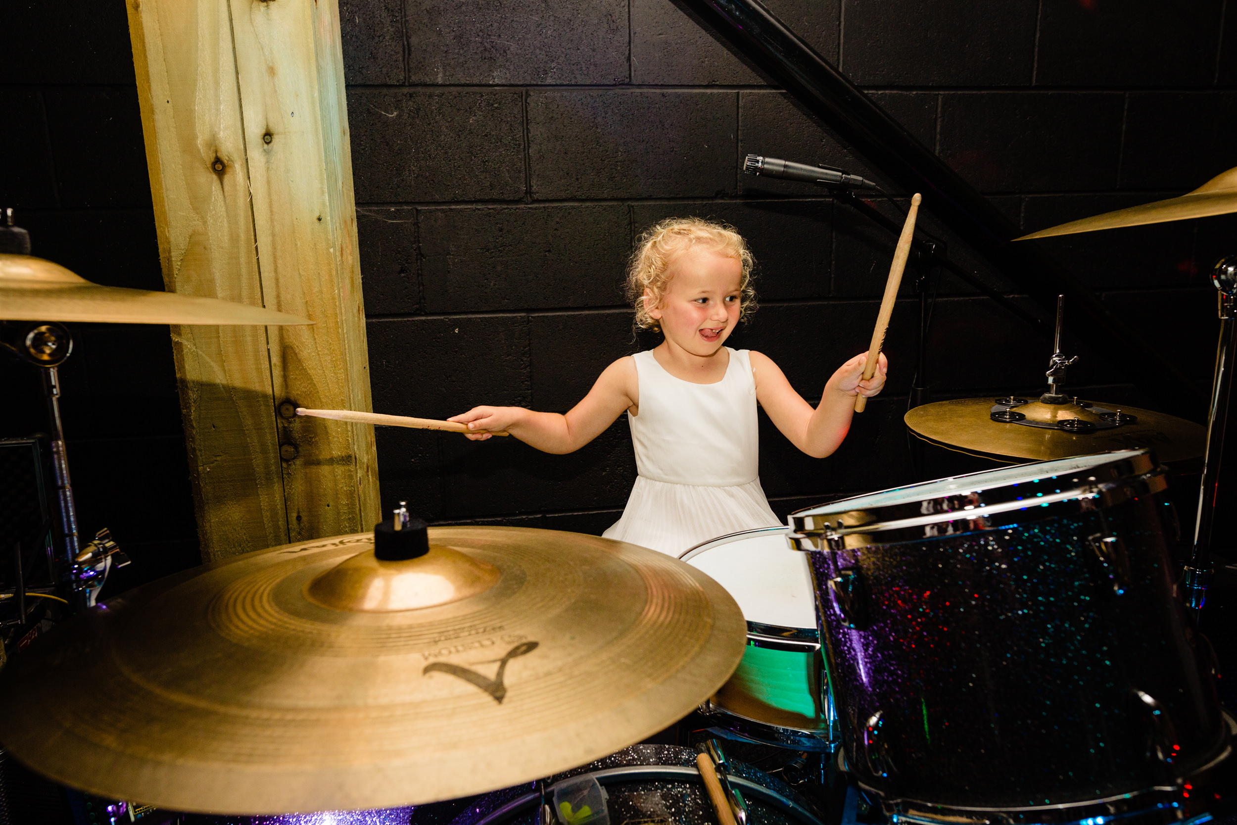 flower girl playing the drums. esk valley wedding photography by emma and rich.