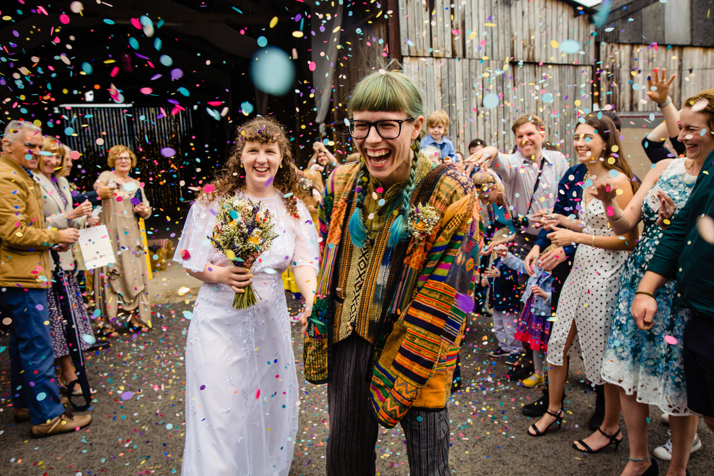 newlyweds being showered in confetti. deepdale farm wedding photography by emma and rich.