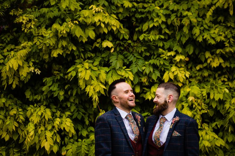 two grooms pictured in front of ivy. ettington park hotel wedding photography by emma and rich.