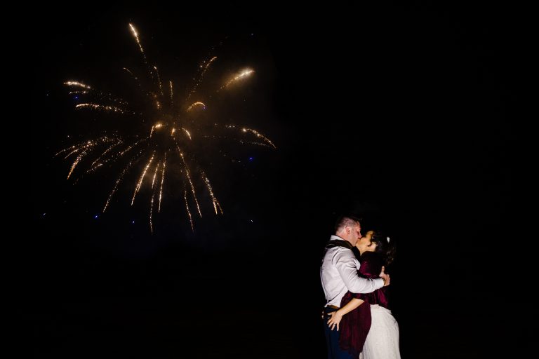 newlyweds kissing under fireworks derby wedding photography by emma and rich