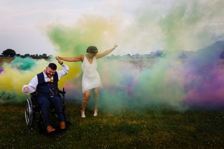 a newly married couple dance amongst coloured smoke. woodstock wedding photography by emma and rich.