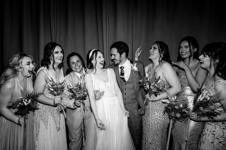 a wedding party having a ;augh in between group shots. the venue halifax wedding photography by emma and rich.