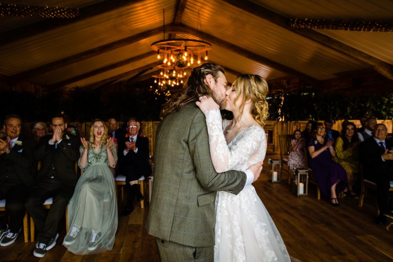 bride and grooms first kiss in front of the ceremony. woddstock york wedding photography by emma and rich.