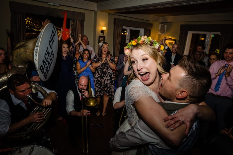 a groom lifts his bride in the air on the dancefloor. little fox wedding photography by emma and rich