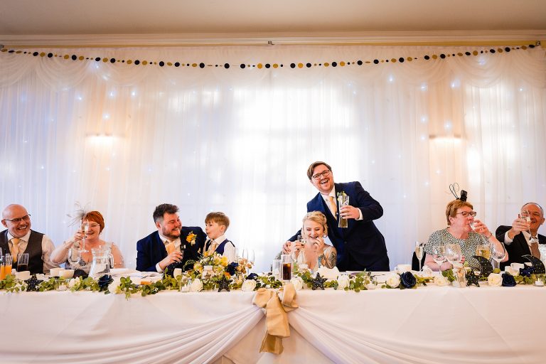 Bride and groom sat at top table during speeches at a Ansty Hall Wedding - Photography by Emma and Rich