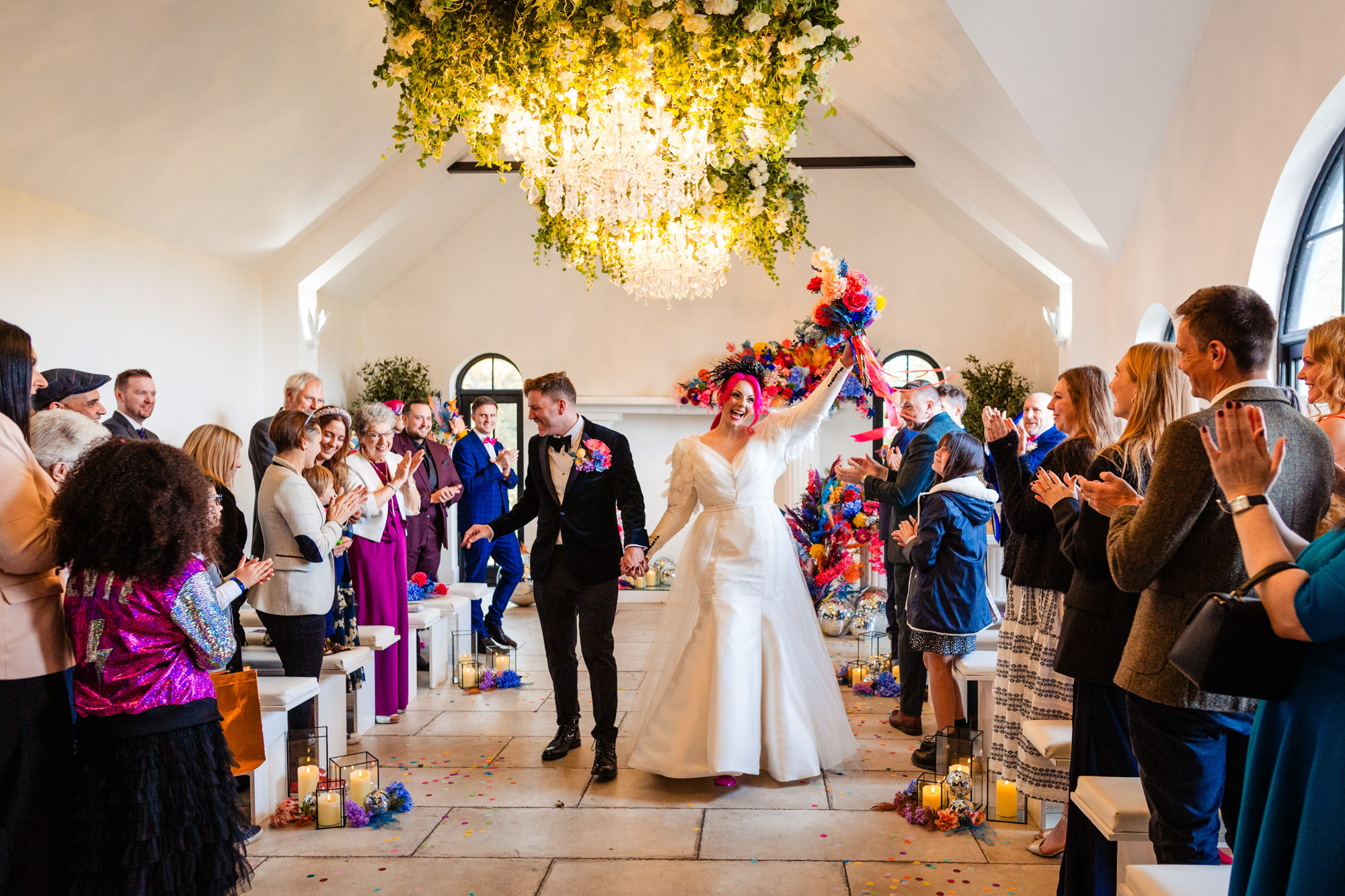 bride and groom leaving the ceremony of their wedding at woodhill hall - wedding photography by emma and rich